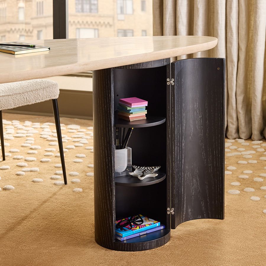 The Oeuf Travertine Desk blends mid century-inspired design with luxe materials, featuring a travertine top, ebonized oak supports, and hidden storage.
