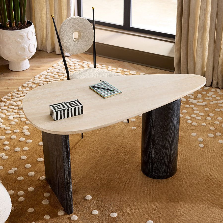 The Oeuf Travertine Desk blends mid century-inspired design with luxe materials, featuring a travertine top, ebonized oak supports, and hidden storage.