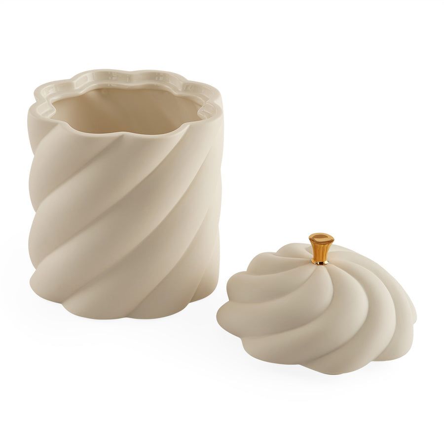 A sculptural, high-fired porcelain box with a luxe gold pull, perfect for adding elegance to any table or space.