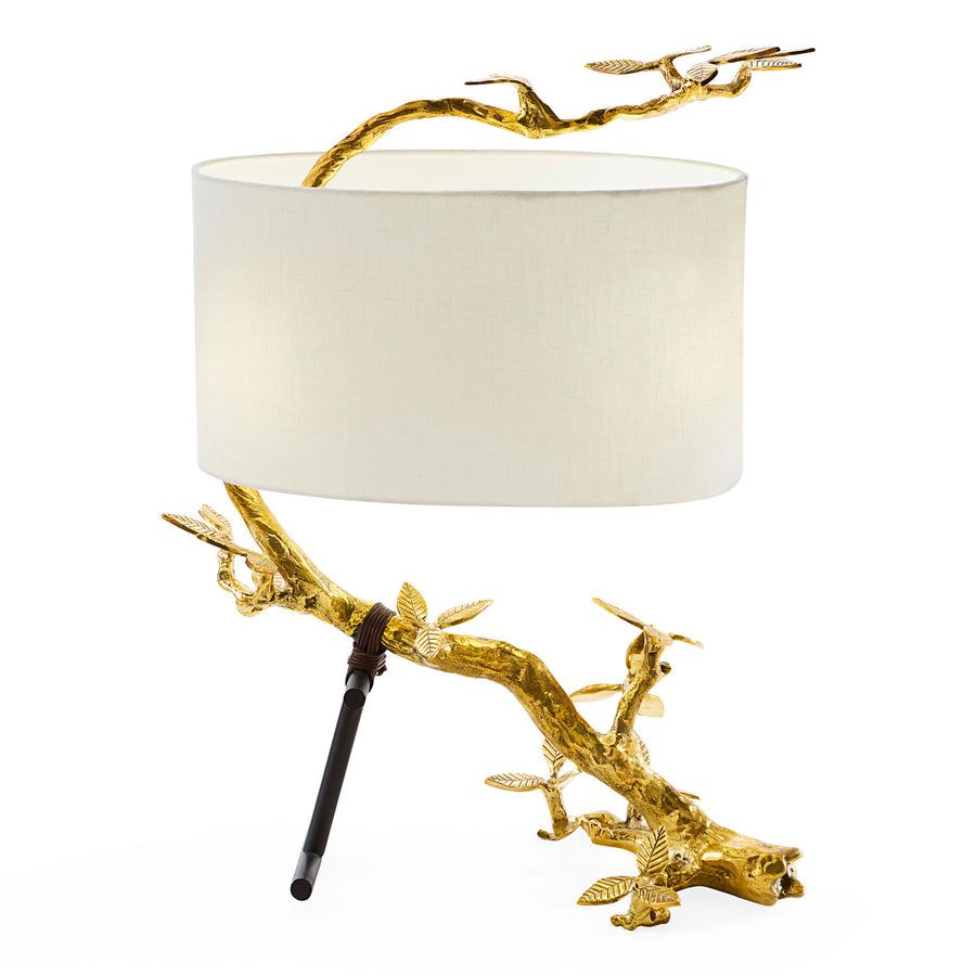 The Kyoto Table Lamp features a twisted brass branch with leather straps, adding a touch of natural glamour to any space.