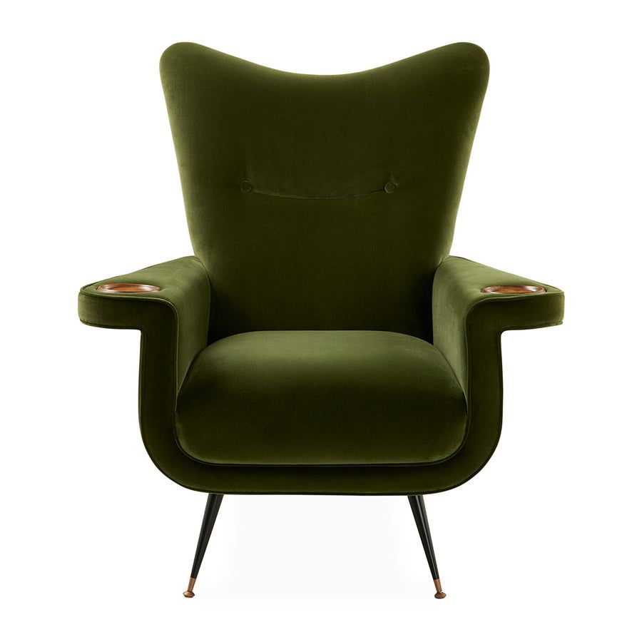The Pierre Lounge Chair features a swooping silhouette, emerald velvet upholstery, and a built-in wood coaster, making it a glamorous addition to any space.