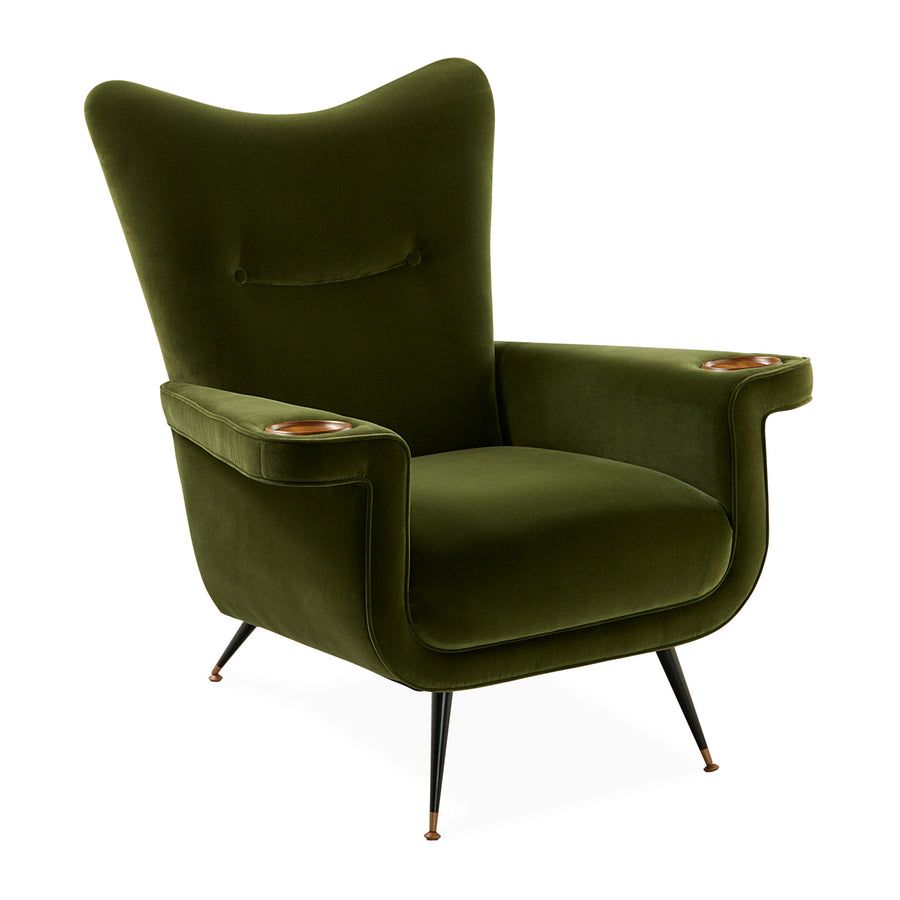 The Pierre Lounge Chair features a swooping silhouette, emerald velvet upholstery, and a built-in wood coaster, making it a glamorous addition to any space.