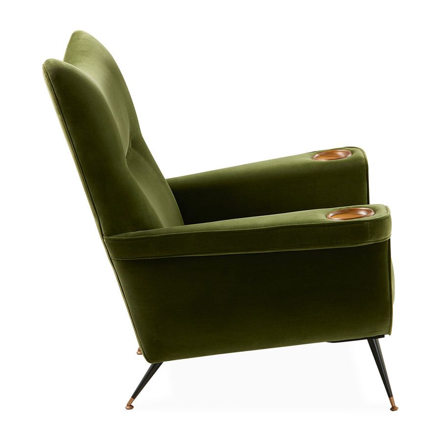The Pierre Lounge Chair features a swooping silhouette, emerald velvet upholstery, and a built-in wood coaster, making it a glamorous addition to any space.