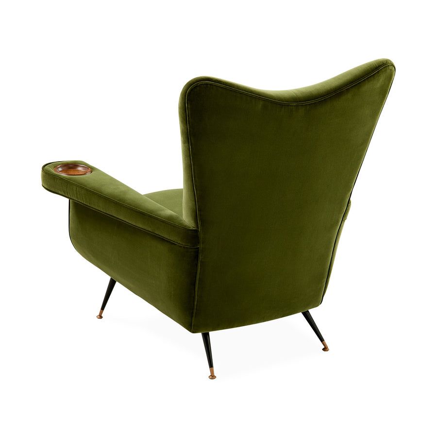 The Pierre Lounge Chair features a swooping silhouette, emerald velvet upholstery, and a built-in wood coaster, making it a glamorous addition to any space.