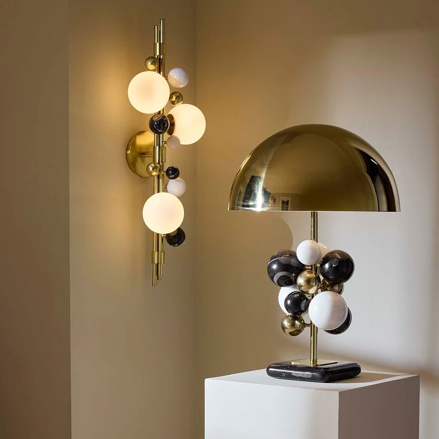 Illuminate your space with the Globo Three-Light Sconce, featuring a sleek design and warm glow, perfect for any room's ambiance.