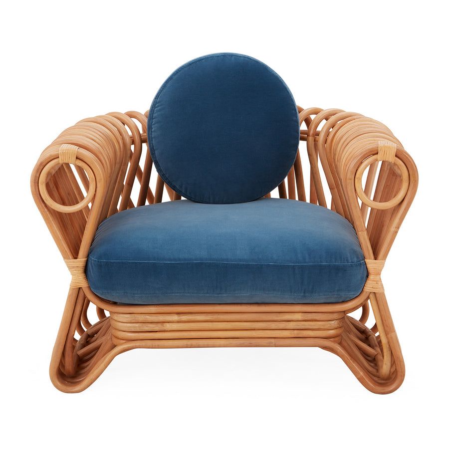 The St Tropez Lounge Chair blends coastal charm and haute couture with hand-coiled reeds and blue velvet cushions, finished with satin lacquer.