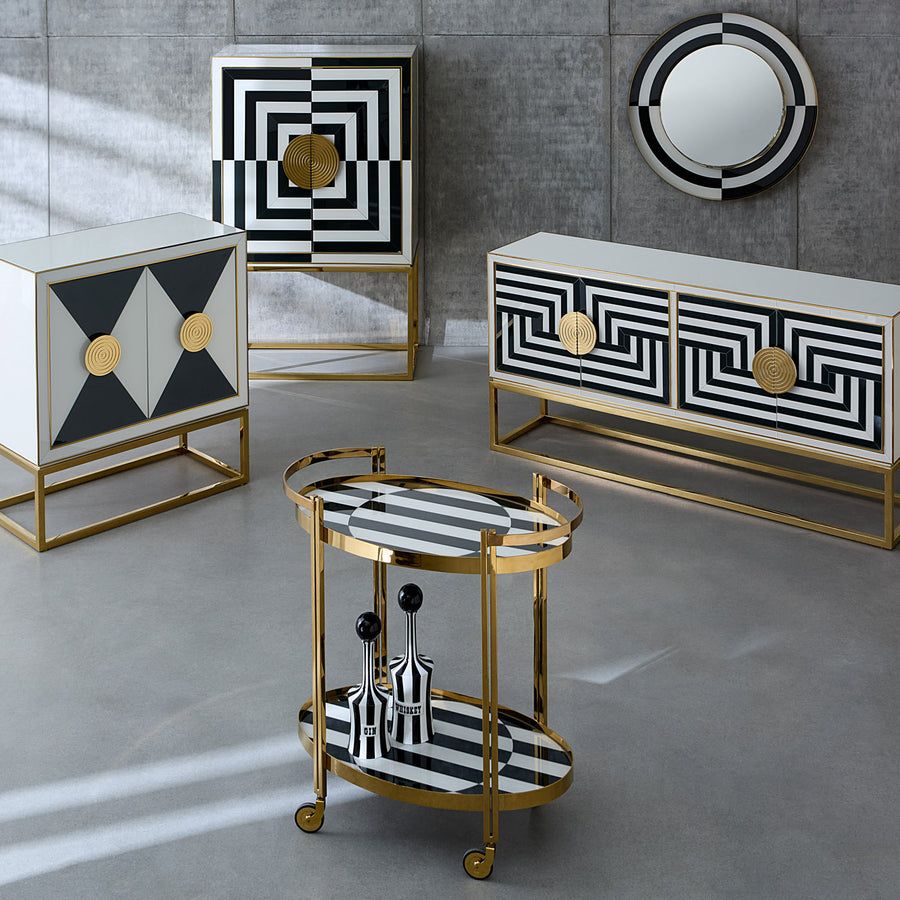 The Op Art Cabinet is a striking modernist piece with back-painted glass panels, polished brass accents, and adjustable interior shelving for functional elegance.