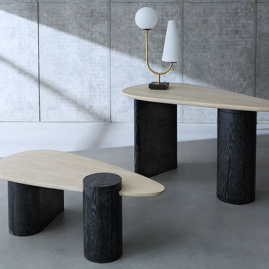 The Oeuf Travertine Desk blends mid century-inspired design with luxe materials, featuring a travertine top, ebonized oak supports, and hidden storage.