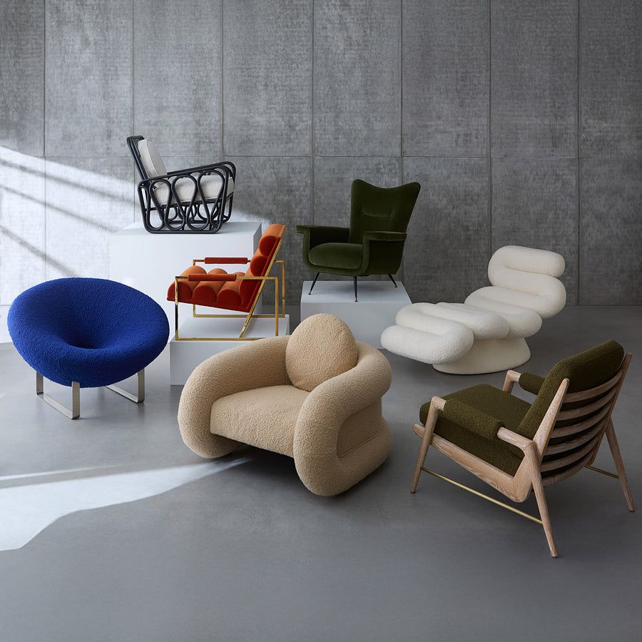 The Pompidou Lounge Chair is a deep, cozy cocoon with a tubular framework, upholstered in Valais Latte bouclé for ultimate comfort.