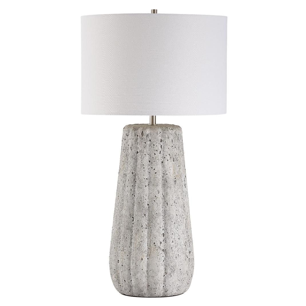 This ceramic lamp features a weathered stone finish, brushed nickel accents, and a soft off-white linen shade, bringing timeless elegance and classic sophistication to any space.