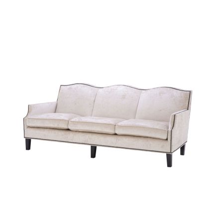 velvety off-white 3 seater sofa with bronze accents and black tapered legs 