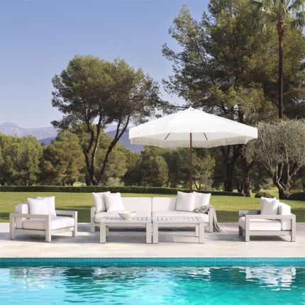 A luxurious outdoor sofa with a sand-coloured frame and natural-toned upholstery 