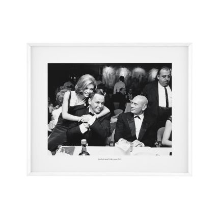Portrait of Nancy Sinatra embracing her father, Frank as Yul Brynner looks on