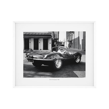 Black and white photograph of Steve McQueen in 1963 driving his jaguar