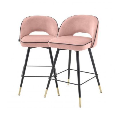 A pair of pink velvet mid-century counter stool with black faux leather piping and golden feet caps