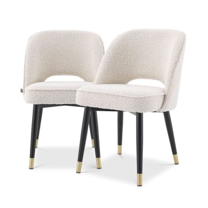 Stunning upholstered chair with black tapered legs and brass caps. 