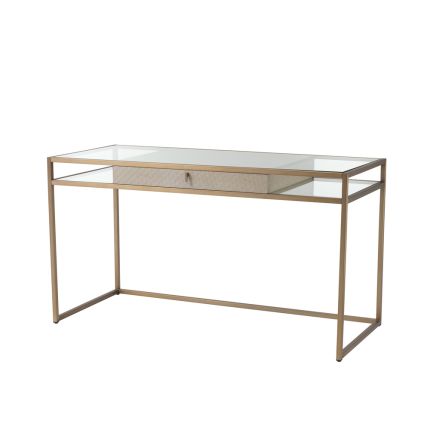 A luxurious brushed brass desk with a clear shelf and lower shelving