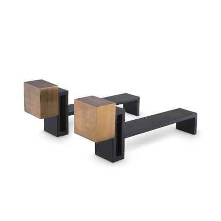 A luxury set of andirons by Eichholtz which feature vintage brass blocks and a black finish