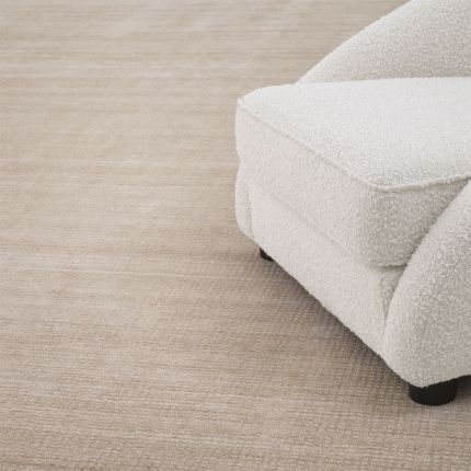 Beige toned low pile rug with a smooth velvet finish by Eichholtz