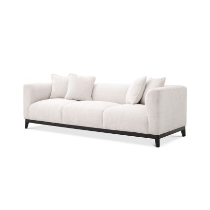 A sumptuous sofa by Eichholtz with a Lyssa Off-White upholstery, black base and four scatter cushions