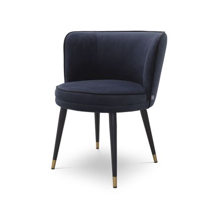 A luxurious dining chair with a dark blue velvet upholstery, swivel seat and gold capped feet