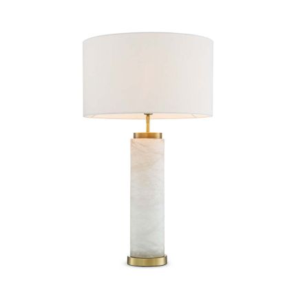 A gorgeous table lamp with brass accents and round shade