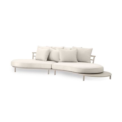 A luxury outdoor sofa by Eichholtz with a sculptural organic shape, stunning sand finish, dreamy off-white upholstery and stylish side table