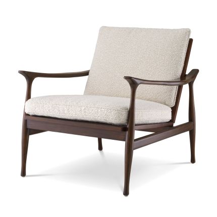 A stylish accent chair by Eichholtz with a brown finished frame and beautiful boucle cream upholstery 