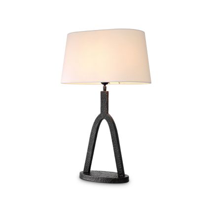 A sophisticated side lamp by Eichholtz with a white fabric shade and hammered bronze base 