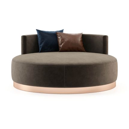 A luxurious round chaise longue with velvet upholstery and a copper-painted stainless steel plinth
