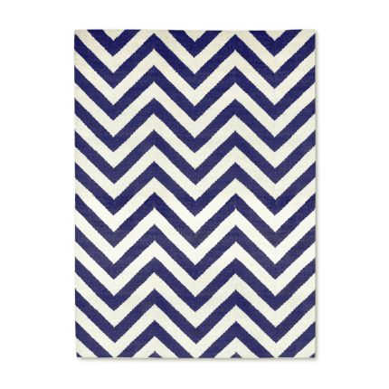 A bold blue and white reversible rug by Jonathan Adler with a zigzag pattern 
