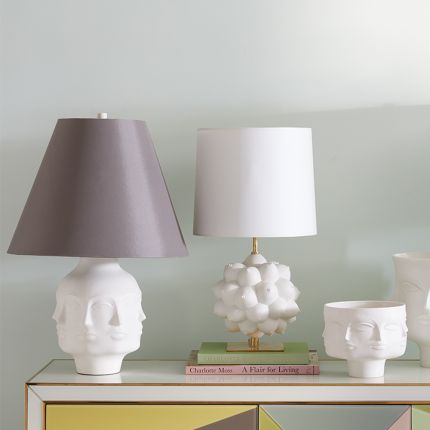 A porcelain faced table lamp with a grey shade and nickel accents 