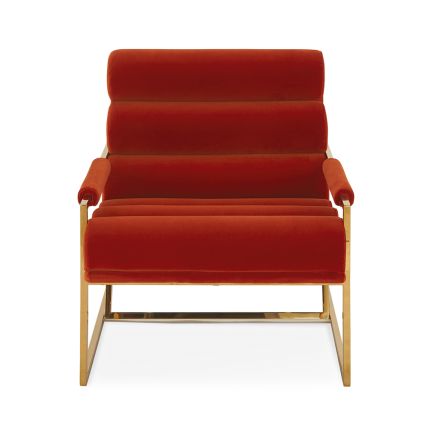 A mid-century modern inspired armchair with burnt orange velvet and a polished brass frame
