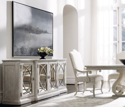Elegant, distressed sideboard with decorated panel doors.