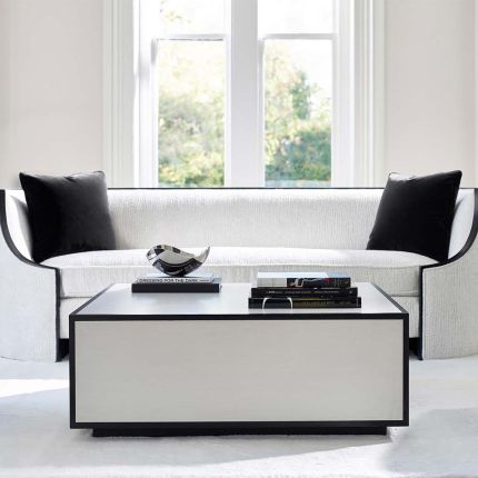 A contemporary coffee table with a graphic, black outline.