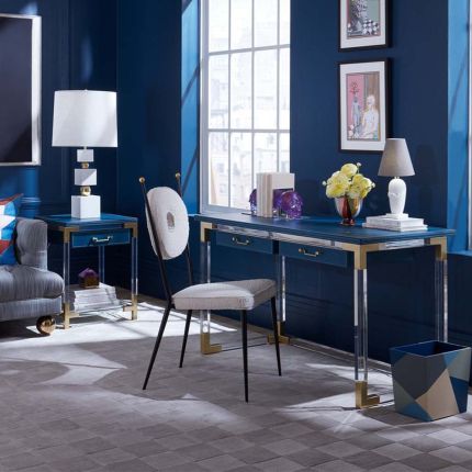A blue leather desk on an acrylic frame with brass accents
