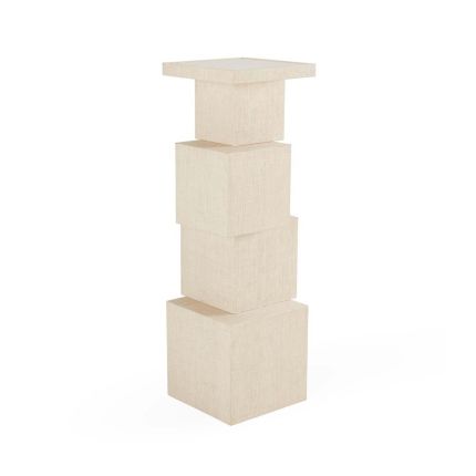 A raffia pedestal made up from stacked cubes.