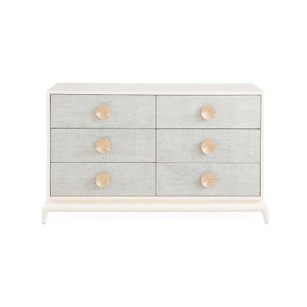 A six drawer dresser with light blue raffia drawer fronts and an ivory lacquered mahogany frame.