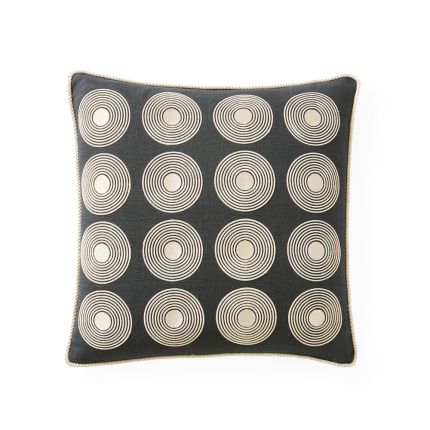 A chic, monochrome cushion with stylish circle cord designs and elegant piping 