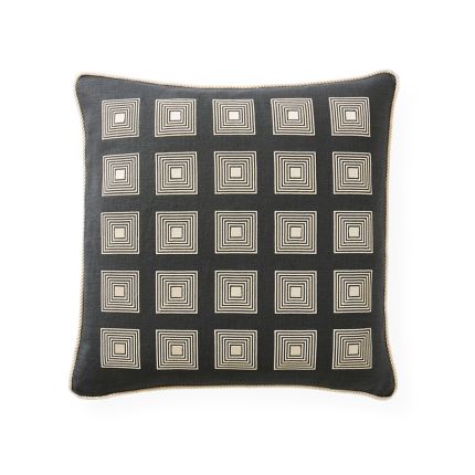 A modern cushion with an art-deco design featuring a square corded pattern and cord piping 