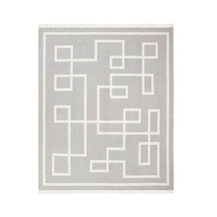 Chic grey rug with graphic white pattern and fringe