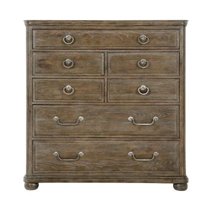 A rustic and dark tall chest of drawers with seven drawers
