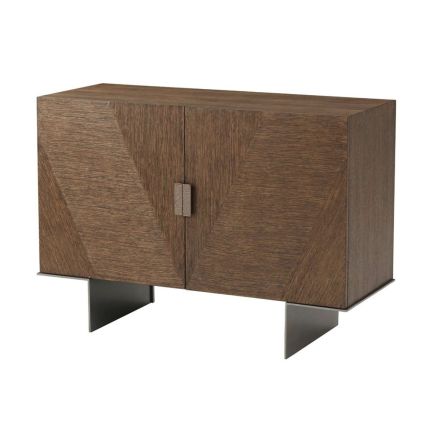 Luxurious cabinet with subtle parquet style doors and brass handles