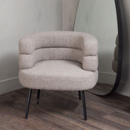 A Mid-Century Modern armchair with Art-Deco influences, a stylish silhouette and a taupe bouclé upholstery 