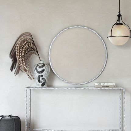 Elegant round wall mirror with textured frame 