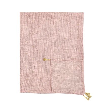 A luxurious pink cotton throw with golden tassels