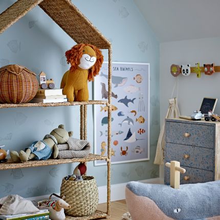 A luxurious natural woven house-shaped kids bookcase
