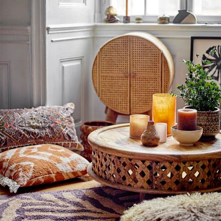Round wooden coffee table with intricately carved sides