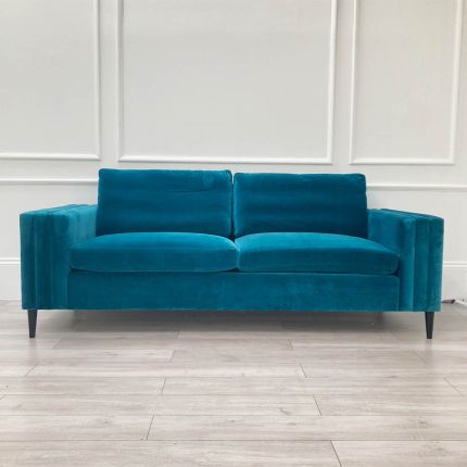 A luxurious teal-coloured 4-seater sofa