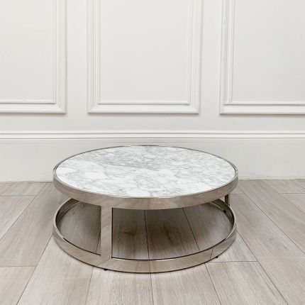 Opulent round table with white marble surface and silver frame